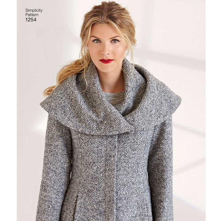 A blonde woman with a loose ponytail wears red lipstick and models the Super Cheap Fabrics Pattern - Simplicity S1254 Misses’ Leanne Marshall Easy Lined Coat, featuring a dramatic collar, against a softly blurred background.