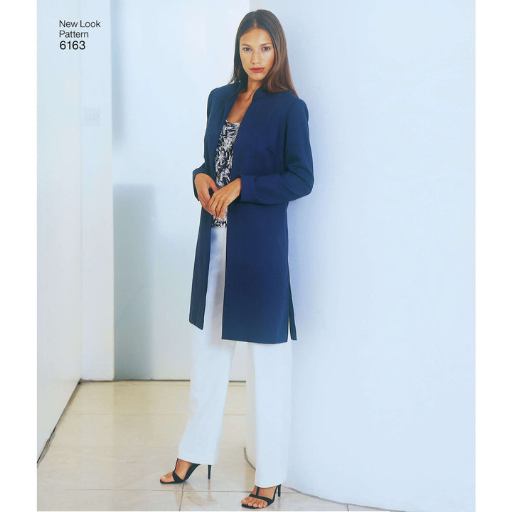 A woman poses confidently indoors against a white wall, wearing the Pattern - NEW LOOK - 6163 - Misses’ Coordinates by Super Cheap Fabrics: a long navy blue coat over a patterned top, tailored trousers, and black heels.