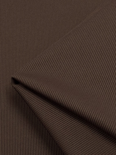 Close-up of Super Cheap Fabrics' Rib Knit in Truffle (130cm), folded neatly. This medium weight fabric has fine parallel lines for a subtle pattern, enhancing its softness and detail.