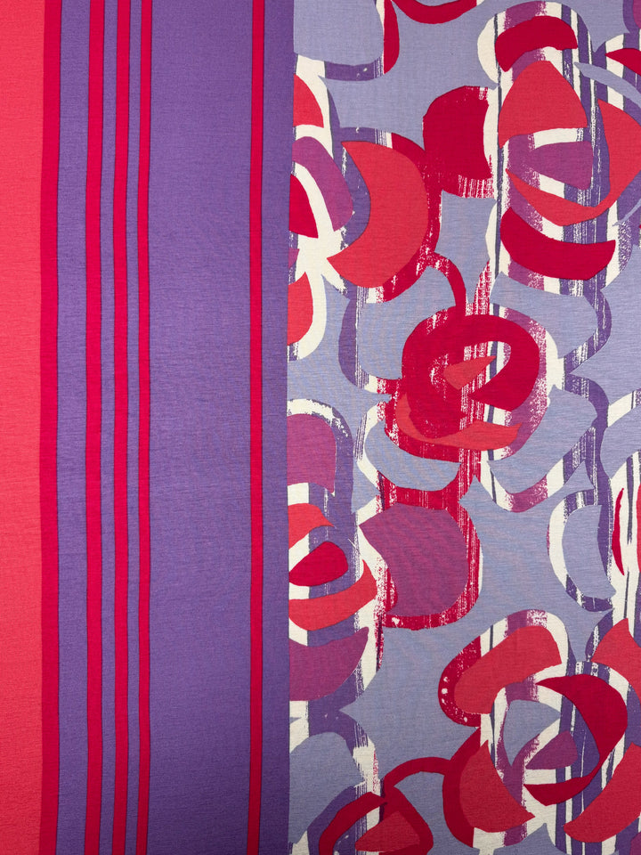 Super Cheap Fabrics’ Viscose Knit - Abstract Striped Geo (150cm) features purple and red vertical stripes on one side and abstract circles in red, magenta, and white over a bluish background on the other.