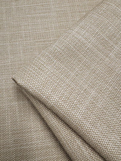 Close-up of folded Upholstery - Rhodes Natural by Super Cheap Fabrics, featuring a beige textured fabric with a subtle dotted pattern, showcasing its weave and soft texture, perfect for adding elegance to any space.