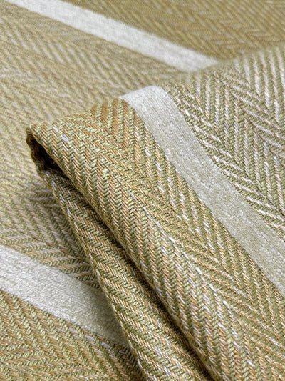 Close-up of the folded Upholstery Herringbone - Hickory fabric by Super Cheap Fabrics, 148cm wide, with a heavy weight and intricate beige and light khaki herringbone weave. The texture and alternating lighter stripes add depth to the design.