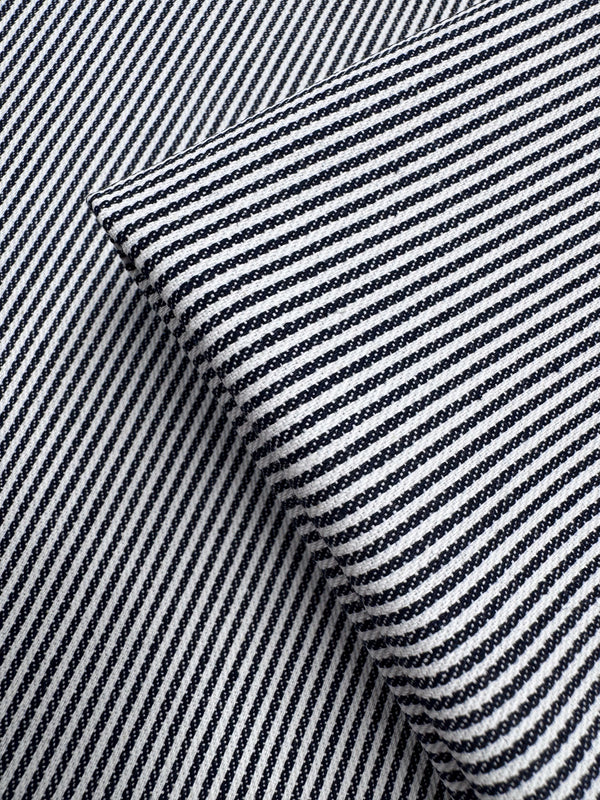 Close-up of two overlapping pieces of Super Cheap Fabrics’ Designer Cotton - Pintrack (150cm), showing black and white diagonal stripes at contrasting angles.