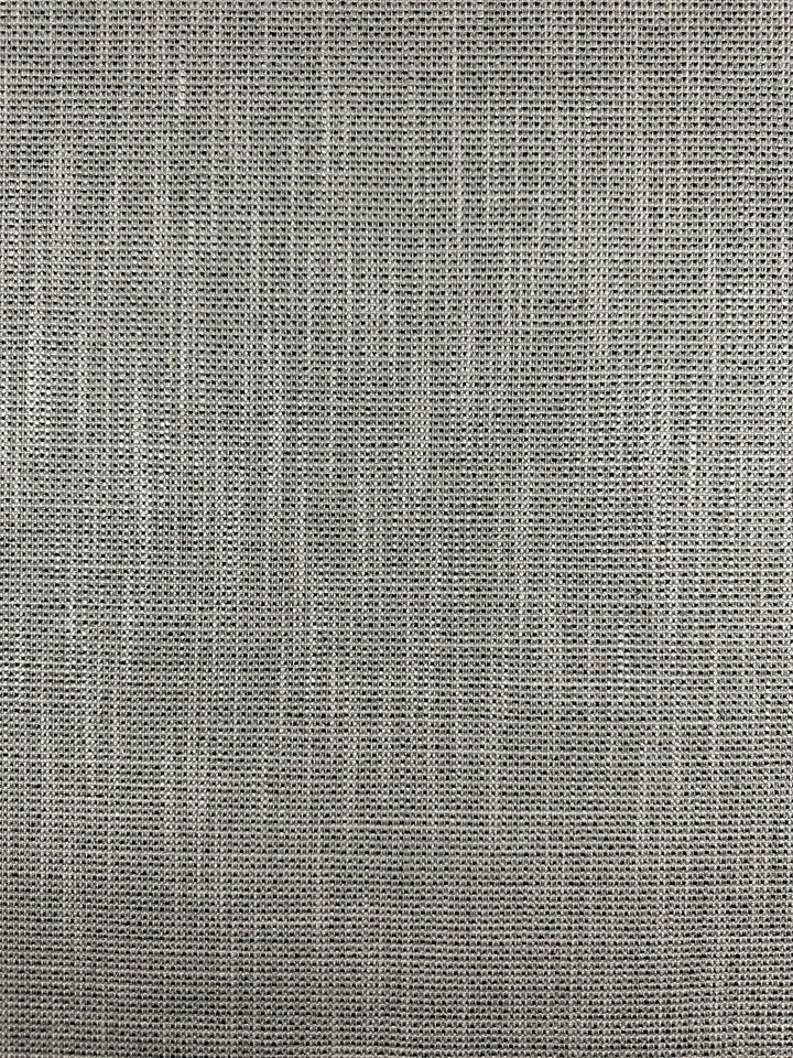 A close-up of "Upholstery Logan - Rhino - 145cm" by Super Cheap Fabrics reveals a gray, heavy-weight fabric with a subtle crisscross pattern. Its visible weave creates a rough texture, offering a rustic, natural look ideal for textured accent pieces.