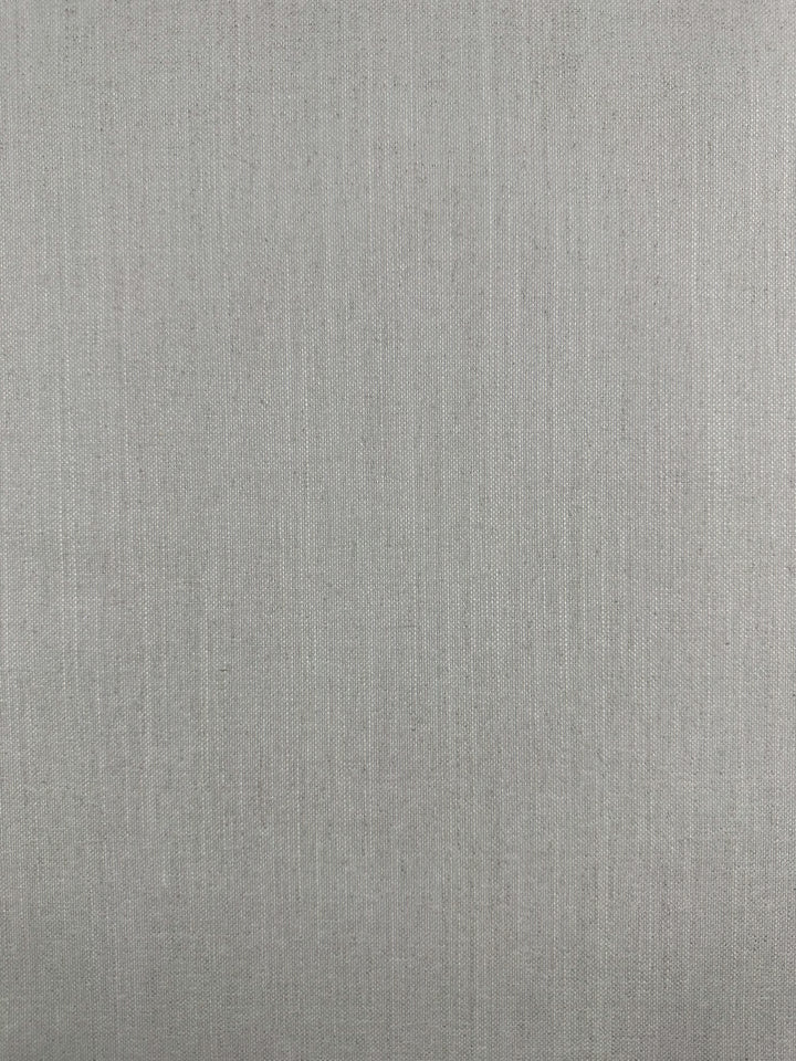 A close-up of Upholstery Basket Weave fabric in Dresden Silver by Super Cheap Fabrics shows a light grey, fine, and smooth texture with an even pattern resembling basket weave, creating a subtle surface design.