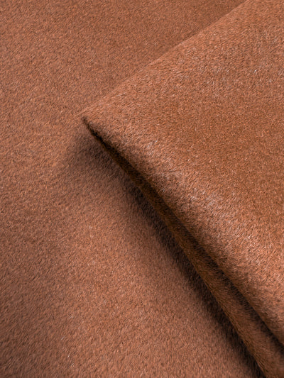Close-up of Super Cheap Fabrics' Wool Cashmere - Dark Hazel (150cm), showing its soft, fuzzy texture and cozy, luxurious feel with a folded section displayed on a flat surface.