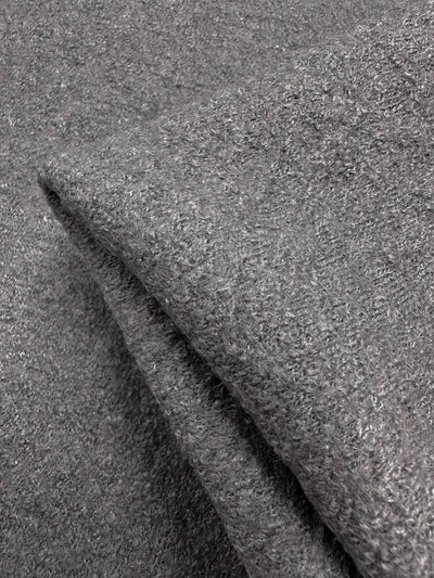 Close-up of two folded grey towels with a soft, textured surface resembling the plushness and luxurious feel of Boiled Wool Gull fabric by Super Cheap Fabrics, showcasing their inviting fluffy loops.