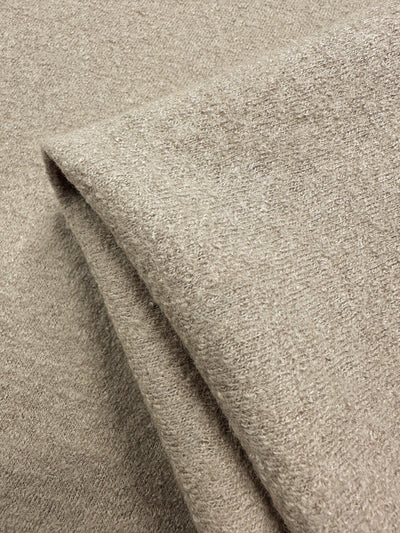 A close-up of Super Cheap Fabrics' Boiled Wool in White Pepper (142cm) reveals its soft, textured surface. This heavyweight wool-viscose blend provides cozy warmth while retaining a light feel.