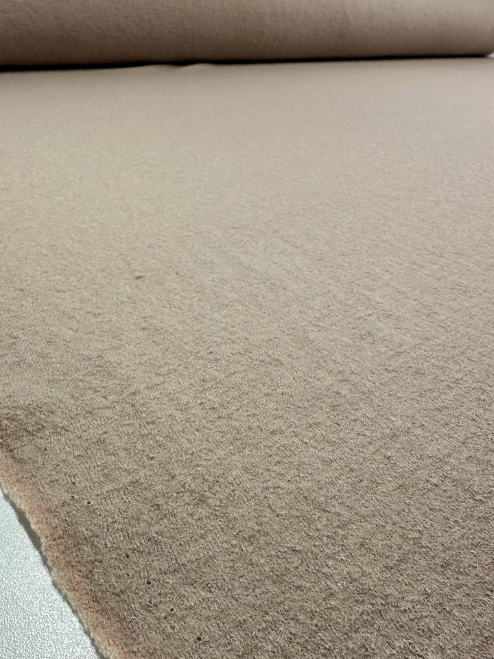 The Boiled Wool - White Pepper from Super Cheap Fabrics showcases a close-up of its heavy-weight, soft, slightly fuzzy texture. The material smoothly extends across the image, measuring 142cm in width.