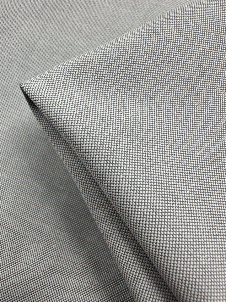 Close-up of folded Linen Blend - Grey White - 150cm by Super Cheap Fabrics, showcasing its fine textured weave and smooth surface, ideal for lightweight upholstery.
