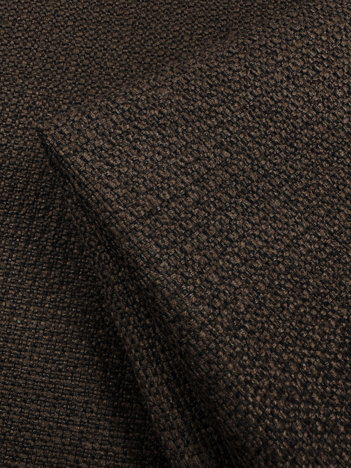 Close-up of the Basket Weave Upholstery - Tuco from Super Cheap Fabrics, featuring a dark brown textured appearance with a coarse basket-like weave. This fabric combines a rugged, heavyweight feel with a rich color and versatile neutral tone. Width: 147cm.