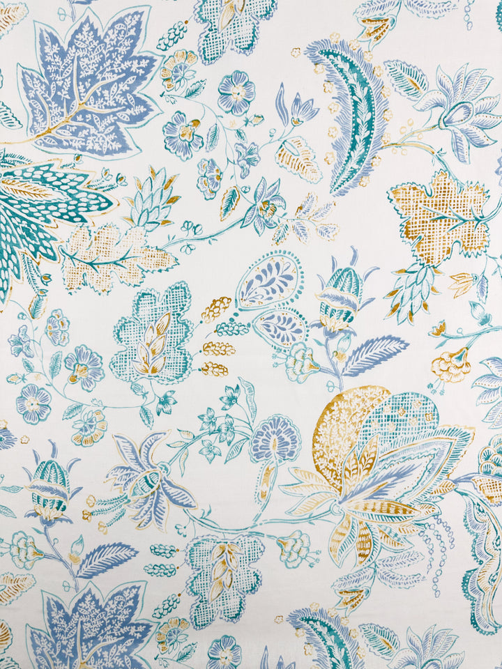 The medium-weight Cotton Duck - Fine Lines fabric by Super Cheap Fabrics features a floral pattern with blue, teal, and yellow leaves and flowers on a light background. Its intricate and symmetrical design is ideal for elegant home décor projects. Width: 147cm.