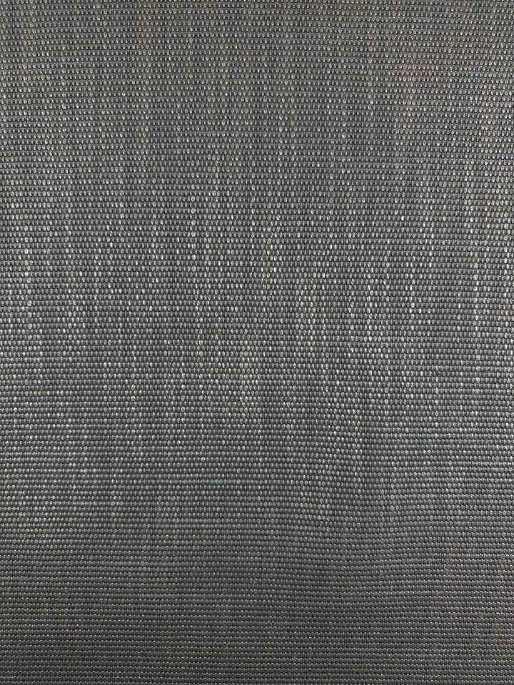 A close-up of Super Cheap Fabrics' Grid Upholstery - Yari 117 - 147cm reveals a gray, lava smoke-like weave with a subtle sheen. This heavy-duty fabric features a durable, fine, tightly woven grid pattern, adding depth and dimension.