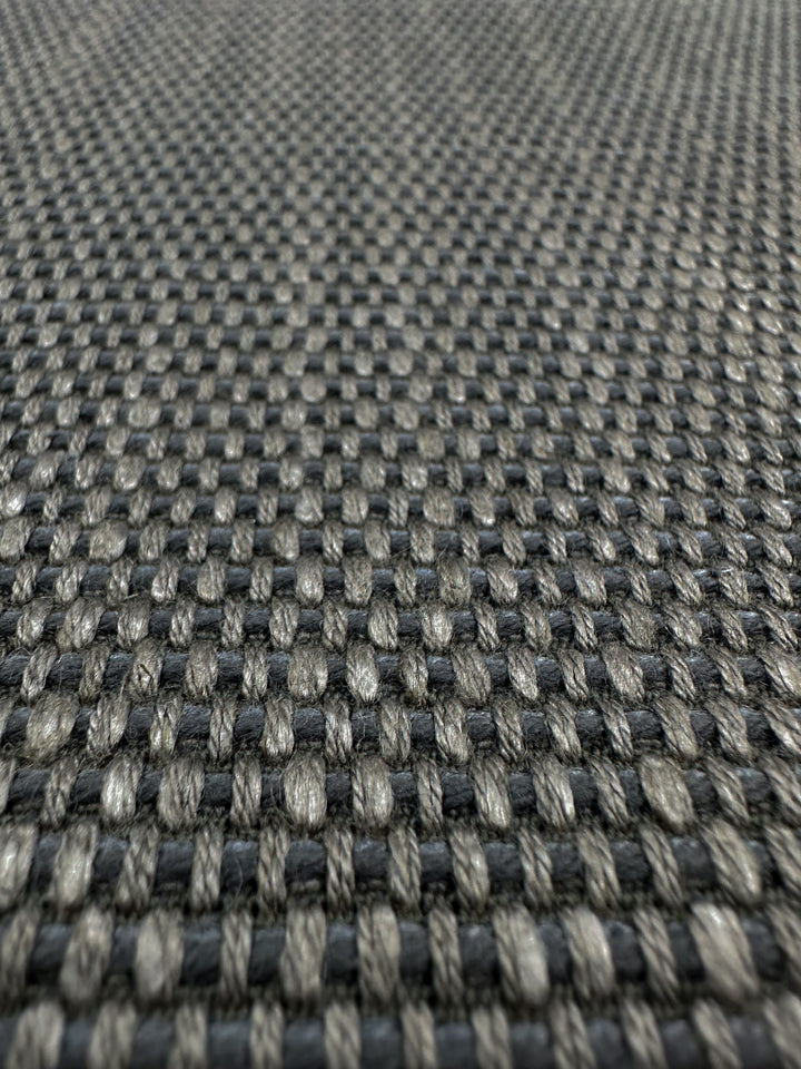 Close-up of Super Cheap Fabrics' Grid Upholstery - Yari 117 - 147cm, showing a heavy-weight checkered pattern in dark and light gray. The intricate thread interlacing highlights high durability and craftsmanship reminiscent of lava smoke.