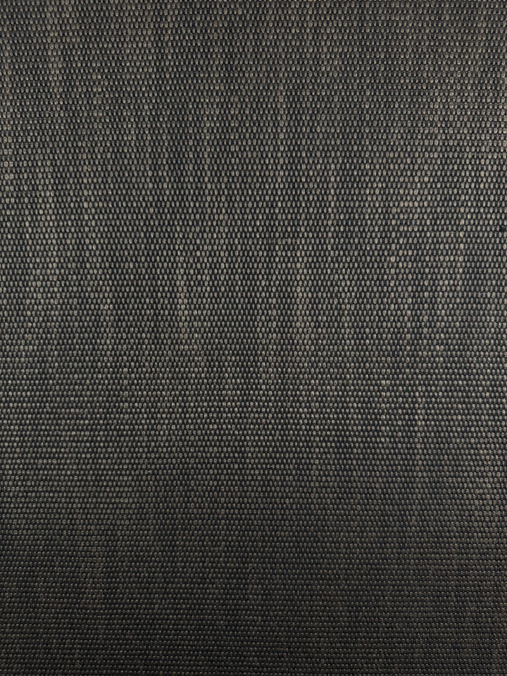 A close-up of the Yari 016 in dark gray by Super Cheap Fabrics highlights its subtle weave pattern. Ideal for heavy-use furniture, this fabric offers a uniform, robust appearance with its intricate design, depth, and high durability. Width: 147cm.