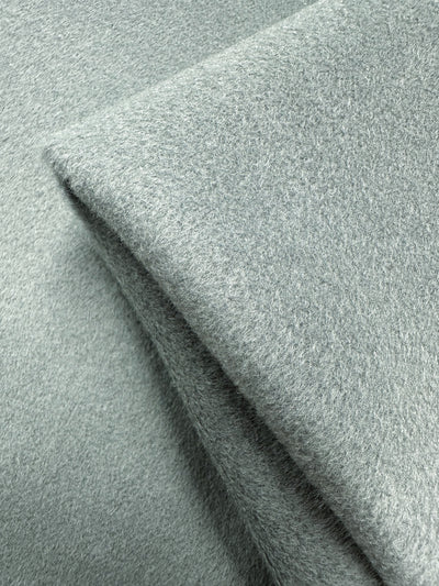 Close-up of the Deadstock Wool Cashmere by Super Cheap Fabrics in Iceberg Green. This 150cm fabric is luxuriously soft and thick, with a plush, slightly fuzzy texture evoking high-quality Italian craftsmanship.