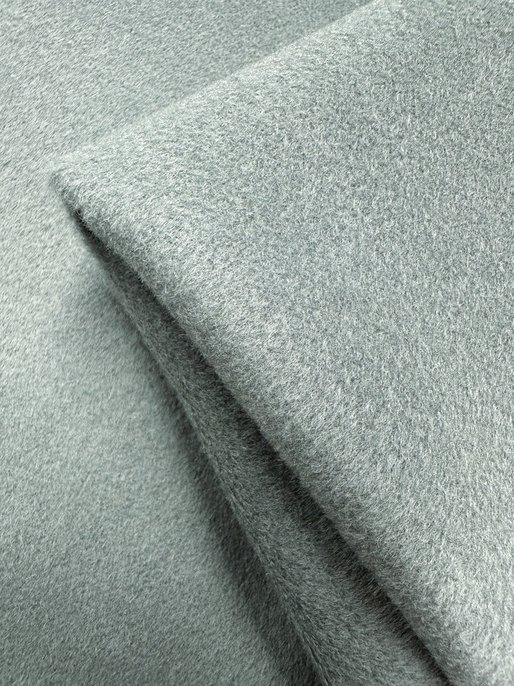 Close-up of the Deadstock Wool Cashmere by Super Cheap Fabrics in Iceberg Green. This 150cm fabric is luxuriously soft and thick, with a plush, slightly fuzzy texture evoking high-quality Italian craftsmanship.