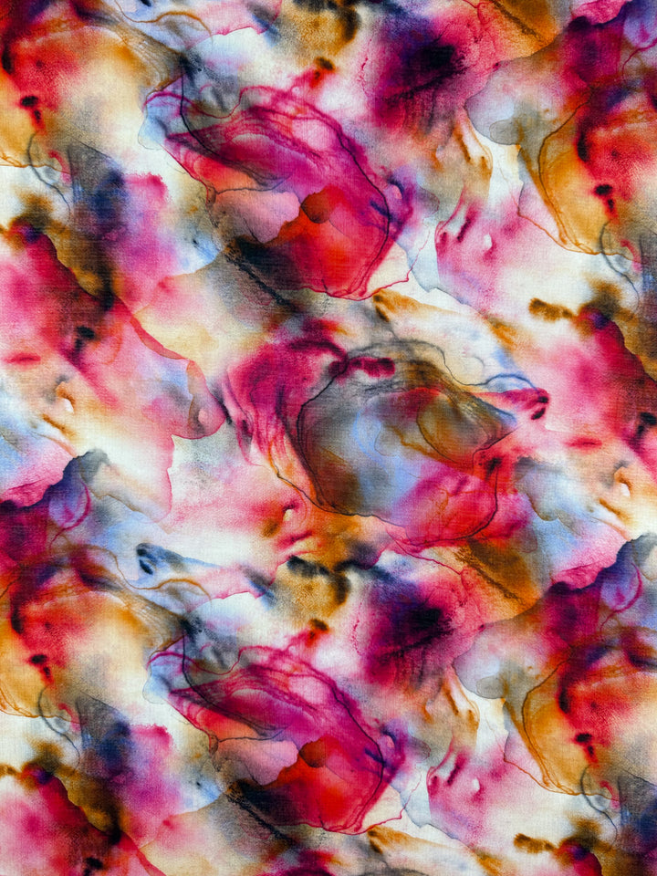 The abstract watercolor design of the Designer Cotton - Zabaleta (150cm) from Super Cheap Fabrics features vibrant red, pink, yellow, and blue swirls with dark accents that blend seamlessly. This creates a dreamy effect ideal for luxury sewing projects.