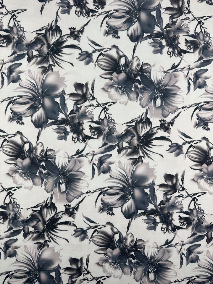 A black and white floral print with large, detailed flowers and leaves over a light background in a soft, watercolor style—perfect for the Designer Deadstock - Inkveil - 145cm from Super Cheap Fabrics.