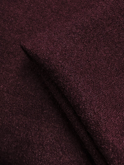 A close-up of Boiled Wool - Port Royale (147cm) by Super Cheap Fabrics shows its soft, fuzzy texture and rich burgundy color, emphasizing the fabric’s heavy weight and quality.