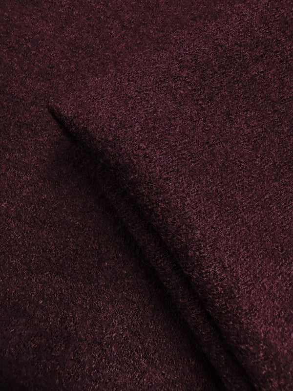 A close-up of Boiled Wool - Port Royale (147cm) by Super Cheap Fabrics shows its soft, fuzzy texture and rich burgundy color, emphasizing the fabric’s heavy weight and quality.
