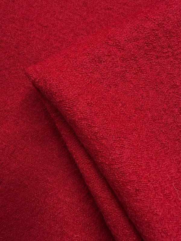 Close-up of Super Cheap Fabrics' Boiled Wool - Crimson (145cm), displaying its soft, textured, and slightly fuzzy red heavyweight wool surface.