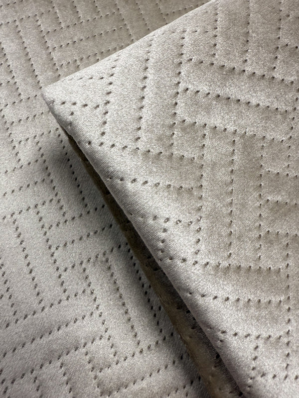 Close-up of Super Cheap Fabrics’ Embossed Velvet - Oatmeal (150cm), an extra heavyweight fabric with a soft texture and geometric zigzag pattern from small, even perforations—perfect for upholstering sofas or armchairs.