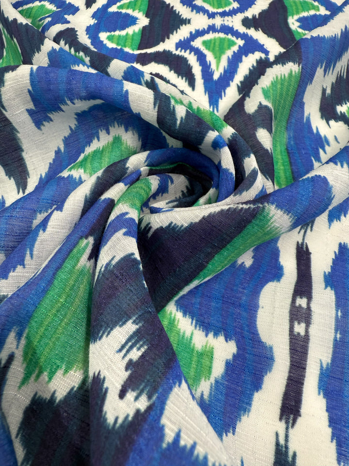 A close-up of Super Cheap Fabrics’ Textured Designer Cotton - Tribal Sea (145cm) highlights its soft, textured weave and blue, green, and white abstract patterns—ideal for luxury sewing projects.