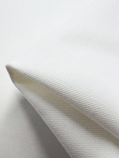 Close-up of Slubbed Linen Drill fabric in vanilla from Super Cheap Fabrics, featuring a heavy weight and visible diagonal seam. The smooth, tightly woven material offers a clean and simple aesthetic. Width: 140cm.