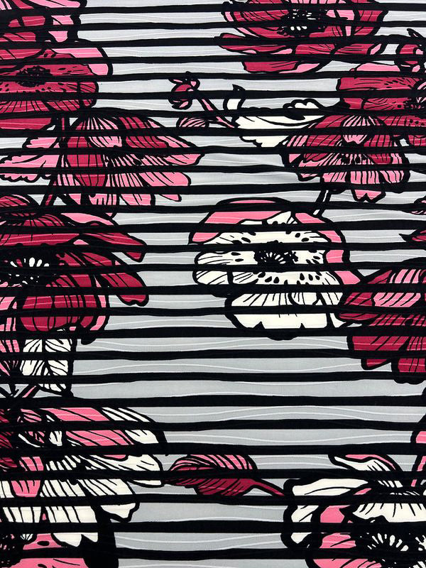 The Textured Lycra - Poppy Dream by Super Cheap Fabrics features large pink, white, and black floral patterns with bold outlines on a backdrop of alternating light and dark gray stripes.